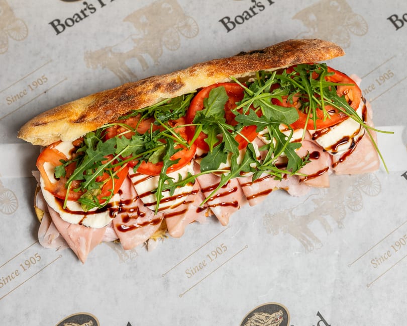 Boar's Head sandwich with mortadella, mozzarella, tomatoes, arugula, and balsamic glaze on ciabatta.