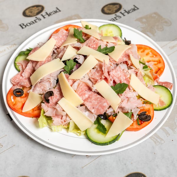 Boar's Head chef salad with sliced meats, cheese, tomatoes, cucumbers, olives, and greens.
